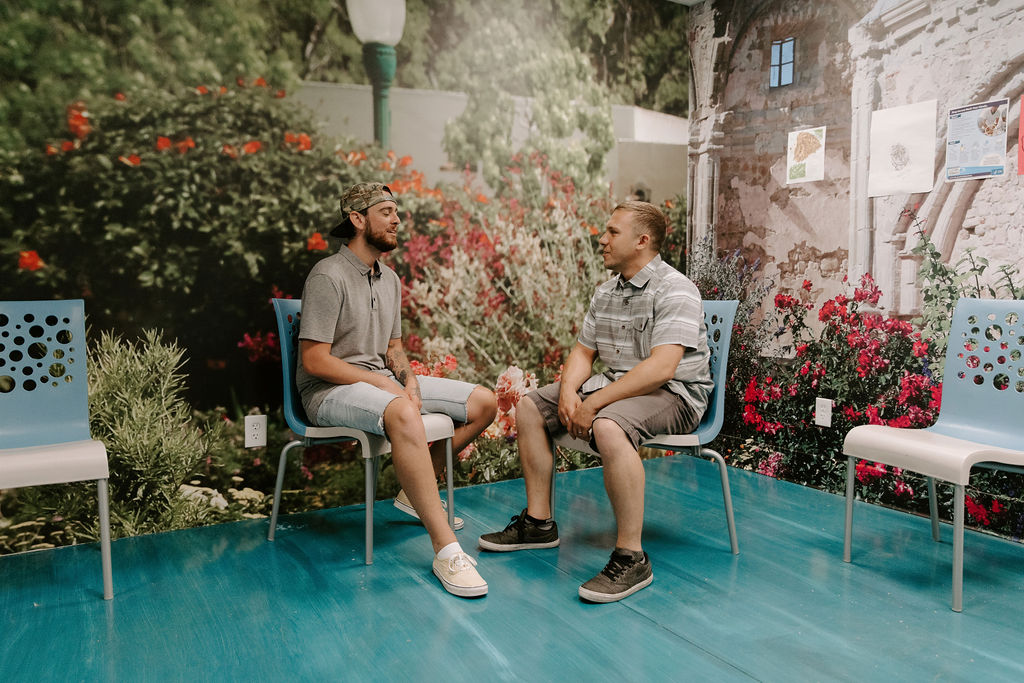 two men talking in treatment program for addiction and mental health